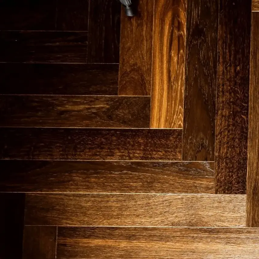 Détail d’un parquet foncé posé en motif géométrique